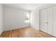 Simple bedroom with hardwood floors and white walls at 126 Marona Ne St, Atlanta, GA 30307