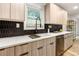 Modern kitchen with quartz countertops, dark hexagonal backsplash, and stainless steel appliances at 126 Marona Ne St, Atlanta, GA 30307