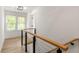 Upstairs hallway with hardwood floors and cable railing at 126 Marona Ne St, Atlanta, GA 30307