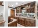 Basement bar featuring custom cabinetry, a sink, and wine racks at 2214 Taylor Grady Ter, Duluth, GA 30097