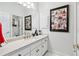 Clean bathroom with white vanity and a framed collage at 2214 Taylor Grady Ter, Duluth, GA 30097