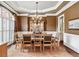 Formal dining room with hardwood floors, chandelier, and large windows at 2214 Taylor Grady Ter, Duluth, GA 30097