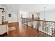 Upper level hallway with hardwood floors and iron railings at 2214 Taylor Grady Ter, Duluth, GA 30097