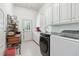 Bright laundry room with washer, dryer, and ample cabinet space at 2214 Taylor Grady Ter, Duluth, GA 30097