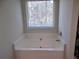 Relaxing bathtub with window view at 2338 Newbury Oaks Dr, Lawrenceville, GA 30044