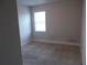 Small bedroom with carpeted floor and window at 2338 Newbury Oaks Dr, Lawrenceville, GA 30044