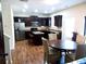 Eat-in kitchen with island, dark cabinets, and hardwood floors at 2338 Newbury Oaks Dr, Lawrenceville, GA 30044