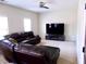 Living room with sectional sofa and large screen TV at 2338 Newbury Oaks Dr, Lawrenceville, GA 30044