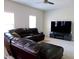 Spacious living room with sectional sofa and large TV at 2338 Newbury Oaks Dr, Lawrenceville, GA 30044