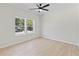 Well-lit bedroom featuring wood-look floors and two windows at 351 Willowwind Dr, Loganville, GA 30052