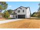 Two-story house with white siding, dark trim, and a two-car garage at 351 Willowwind Dr, Loganville, GA 30052