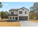 Two-story house with white siding, dark trim, and a two-car garage at 351 Willowwind Dr, Loganville, GA 30052