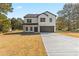 Two-story house with white siding, dark trim, and a two-car garage at 351 Willowwind Dr, Loganville, GA 30052