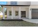 Inviting front porch with white columns and dark door at 351 Willowwind Dr, Loganville, GA 30052