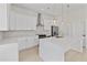 Modern kitchen with white cabinets and a large island at 351 Willowwind Dr, Loganville, GA 30052