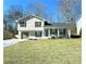 Newly renovated two-story house with a gray garage door and landscaped lawn at 1933 Matthew Way, Lithonia, GA 30058