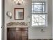 Modern bathroom with granite countertop, tiled floor, and a large mirror at 249 Josephine Ne St, Atlanta, GA 30307