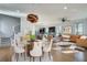 Open concept dining room features a glass table and modern chairs, adjacent to a kitchen and living area at 249 Josephine Ne St, Atlanta, GA 30307