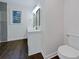 Double vanity bathroom with dark hardwood floors and updated fixtures at 574 Pool Rd, Hiram, GA 30141