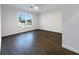 Well-lit bedroom featuring dark hardwood floors and a large window at 574 Pool Rd, Hiram, GA 30141