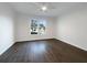 Spacious bedroom featuring hardwood floors and large window at 574 Pool Rd, Hiram, GA 30141
