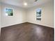 Spacious bedroom with dark hardwood floors and two windows at 574 Pool Rd, Hiram, GA 30141