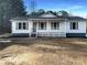 Newly built home featuring a white exterior, gray shutters, and a front porch at 574 Pool Rd, Hiram, GA 30141