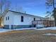 White house exterior with wooden deck, propane tank, and partial snow coverage at 574 Pool Rd, Hiram, GA 30141