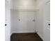 Laundry room with wire shelving and dark hardwood floors at 574 Pool Rd, Hiram, GA 30141