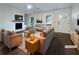 Virtually staged living room with fireplace, hardwood floors, and ample natural light at 574 Pool Rd, Hiram, GA 30141