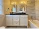 Bathroom boasts a double vanity with dark countertop and bathtub at 6520 Roswell Rd # 3, Atlanta, GA 30328