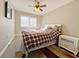 Cozy bedroom with wood-look floors and plaid bedding at 6520 Roswell Rd # 3, Atlanta, GA 30328