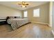 Spacious bedroom with a king-size bed and wood floors at 6520 Roswell Rd # 3, Atlanta, GA 30328