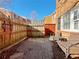 Small brick patio with seating area and wooden fence at 6520 Roswell Rd # 3, Atlanta, GA 30328