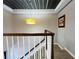 Upstairs hallway with wood railing and unique ceiling at 6520 Roswell Rd # 3, Atlanta, GA 30328