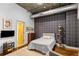 Smaller bedroom with plaid wall and built-in shelving at 123 Luckie Nw St # 2210, Atlanta, GA 30303