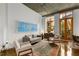 Spacious living room with hardwood floors, large windows, and stylish furniture at 123 Luckie Nw St # 2210, Atlanta, GA 30303