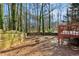 Large backyard with wooden fence and playset at 1741 Charrington Way, Powder Springs, GA 30127