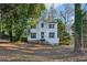 Two-story house with white siding, blue door, and a tree-lined yard at 1741 Charrington Way, Powder Springs, GA 30127