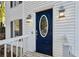 Blue front door with glass oval window and white frame at 1741 Charrington Way, Powder Springs, GA 30127