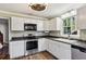 Kitchen with white cabinets, stainless steel appliances, and wood floors at 1741 Charrington Way, Powder Springs, GA 30127