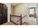 Upstairs hallway with wood railing and carpet at 1741 Charrington Way, Powder Springs, GA 30127