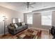 Cozy basement room featuring a gray sofa, floor rug, and two windows at 257 Rock Garden Nw Ter, Marietta, GA 30064