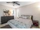 Bright bedroom with a comfortable bed, dresser, and ceiling fan at 257 Rock Garden Nw Ter, Marietta, GA 30064