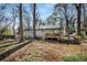 House back view showcasing a deck and wooded backyard at 257 Rock Garden Nw Ter, Marietta, GA 30064