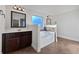 Bathroom with double vanity, soaking tub, and tile flooring at 8372 Members Dr, Jonesboro, GA 30236