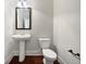 Convenient powder room with pedestal sink and toilet at 8372 Members Dr, Jonesboro, GA 30236