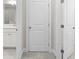 Hallway with white doors and neutral colored walls at 896 Farmstead Rd, Suwanee, GA 30024