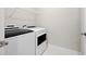 Bright laundry room with washer, dryer and shelving at 896 Farmstead Rd # 162, Suwanee, GA 30024