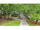 Tree-lined driveway leads to charming home with circular drive at 110 Golf Terrace Dr, Stockbridge, GA 30281